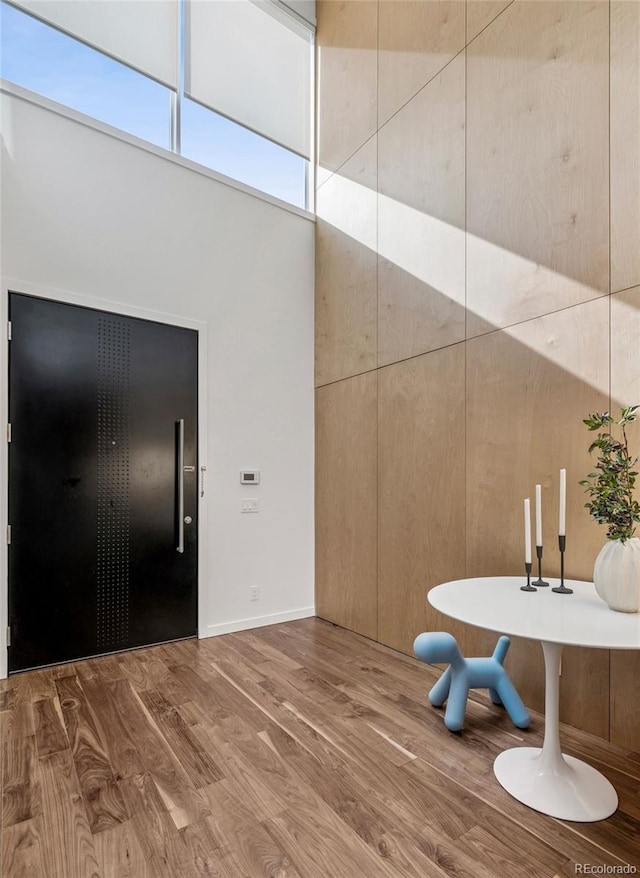 interior space with a high ceiling and wood finished floors