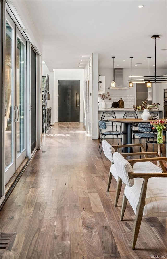 interior space with recessed lighting, visible vents, and wood finished floors