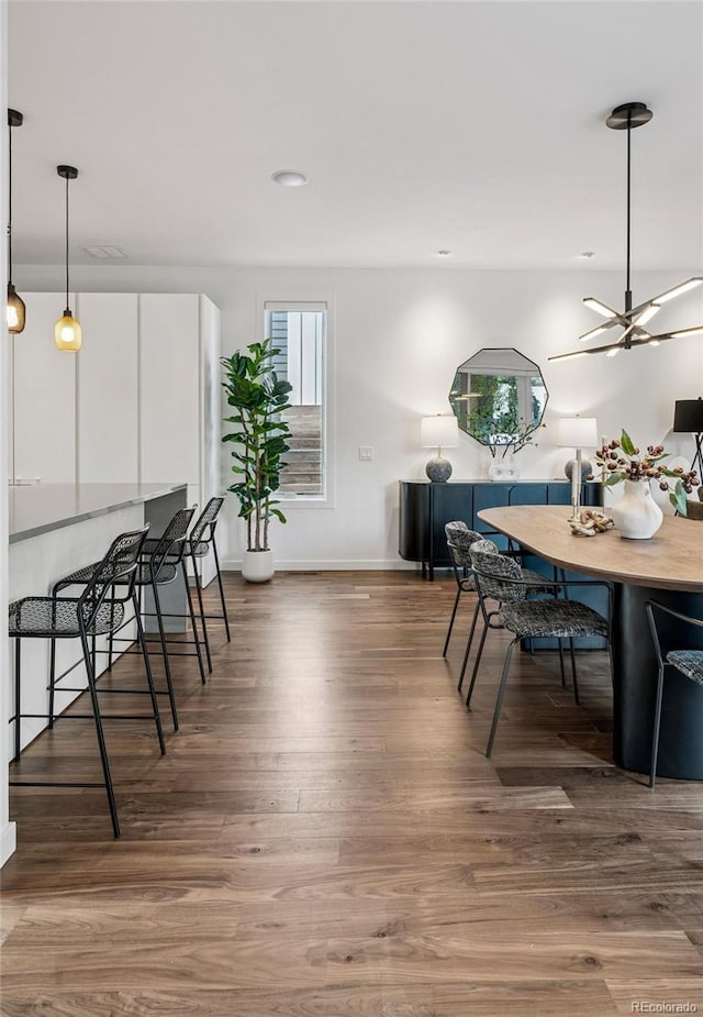 dining area with baseboards, ceiling fan, recessed lighting, and wood finished floors
