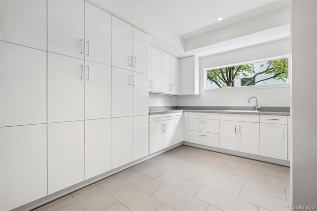 kitchen featuring a sink and white cabinetry