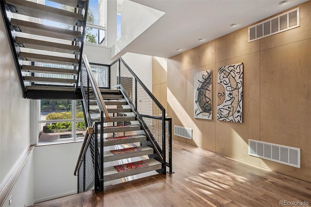 stairway featuring visible vents and a healthy amount of sunlight