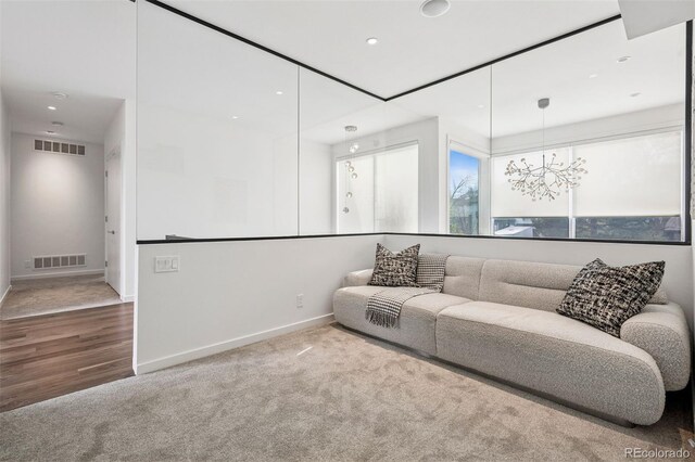 carpeted living area featuring visible vents, recessed lighting, and baseboards