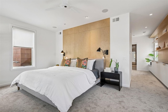 bedroom featuring visible vents, baseboards, and light carpet