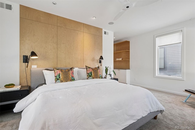 bedroom featuring visible vents, baseboards, and light carpet