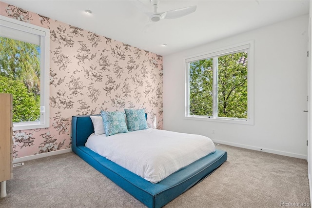 bedroom with baseboards, carpet flooring, ceiling fan, and wallpapered walls