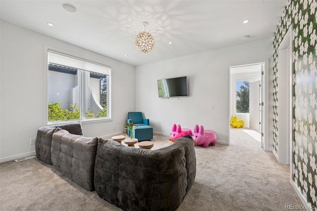 living area with plenty of natural light, carpet, and recessed lighting