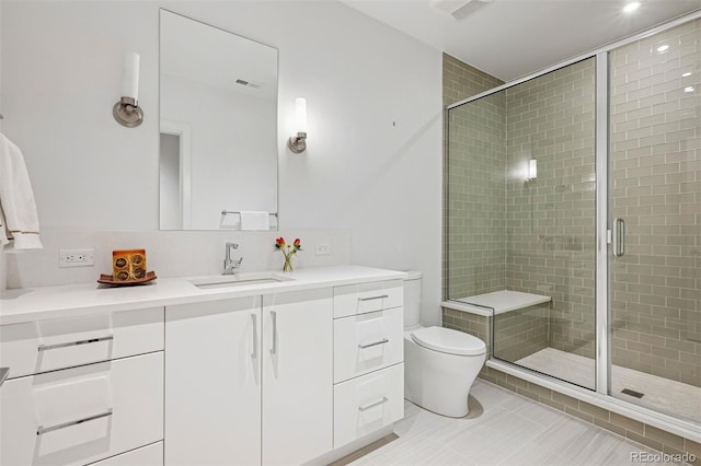 bathroom with vanity, a stall shower, toilet, and visible vents
