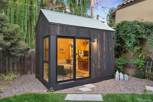 view of outbuilding with fence and an outdoor structure