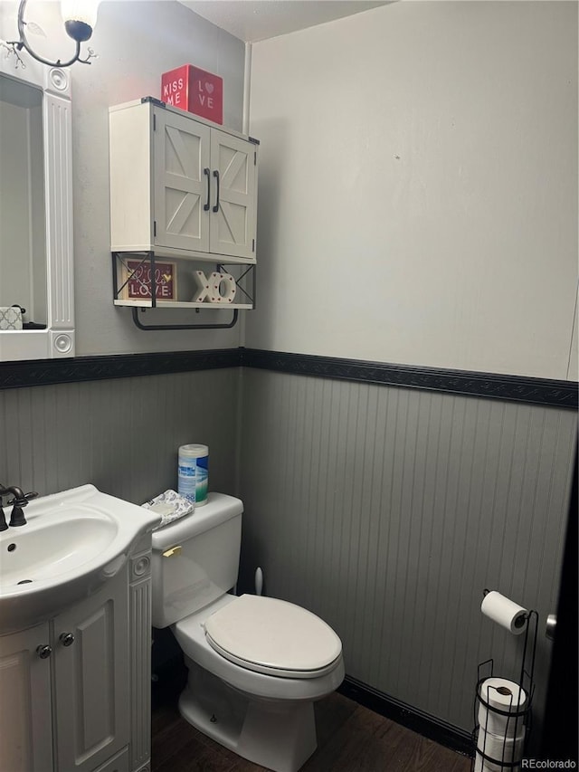 1254 S Reed St Unit 1, Lakewood, CO 80232 - bathroom with wainscoting, wood finished floors, and vanity