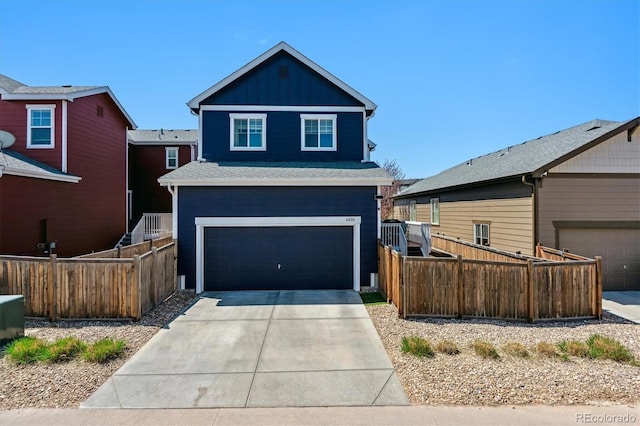 traditional-style home featuring an attached garage, driveway, fence, and board and batten siding