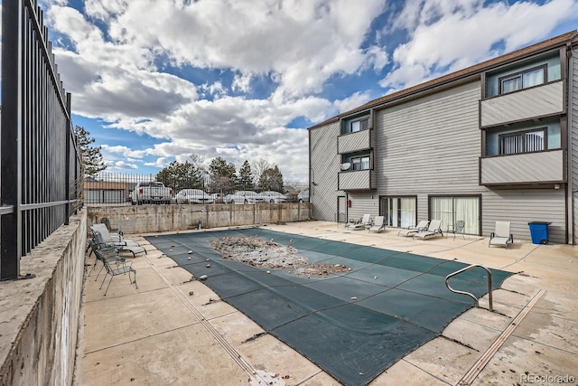 view of pool with a fenced in pool, fence, and a patio