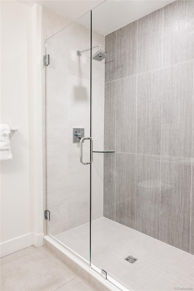 bathroom featuring tile patterned floors and an enclosed shower