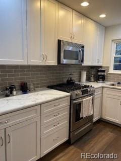 9060 E Cherry Creek S Drive E, Denver, CO 80231 - kitchen featuring stainless steel appliances, decorative backsplash, white cabinets, and recessed lighting