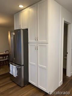 9060 E Cherry Creek S Drive E, Denver, CO 80231 - kitchen with freestanding refrigerator, dark wood finished floors, white cabinets, and recessed lighting
