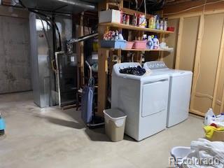 9060 E Cherry Creek S Drive E, Denver, CO 80231 - washroom featuring washing machine and dryer and heating unit