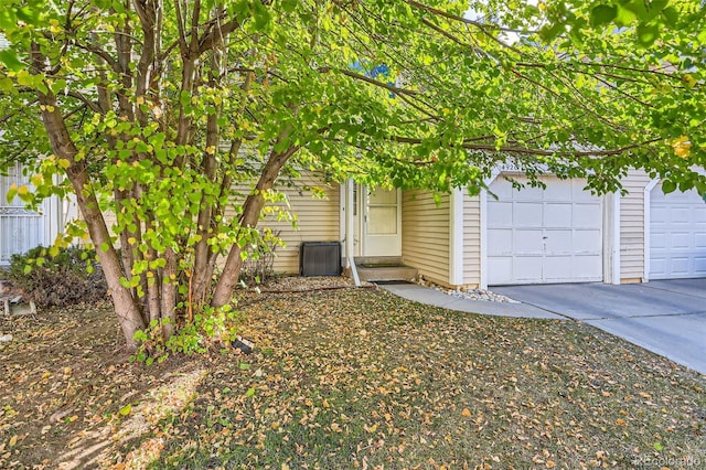 view of front of house with concrete driveway, entry steps, and an attached garage