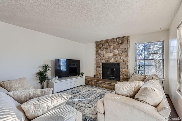 living room featuring a fireplace and a textured ceiling