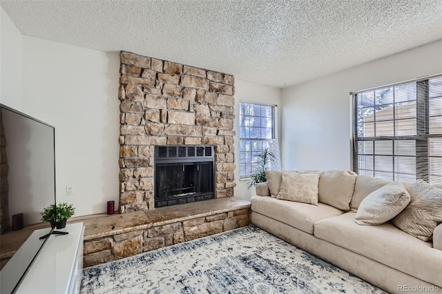 living area featuring a textured ceiling and a fireplace