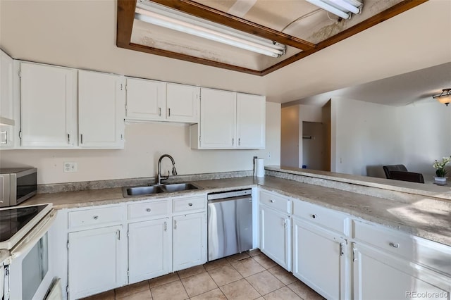 kitchen featuring light tile patterned floors, white cabinets, a sink, light countertops, and appliances with stainless steel finishes