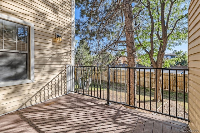wooden terrace featuring fence