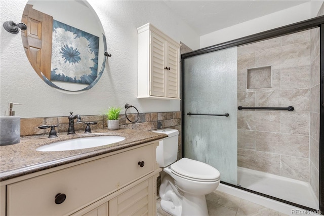 16308 E Wyoming Dr, Aurora, CO 80017 - bathroom with vanity, a shower stall, toilet, and tile patterned floors