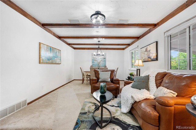 16308 E Wyoming Dr, Aurora, CO 80017 - carpeted living room featuring beam ceiling, a chandelier, and baseboards