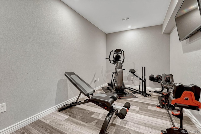 workout area featuring light hardwood / wood-style flooring