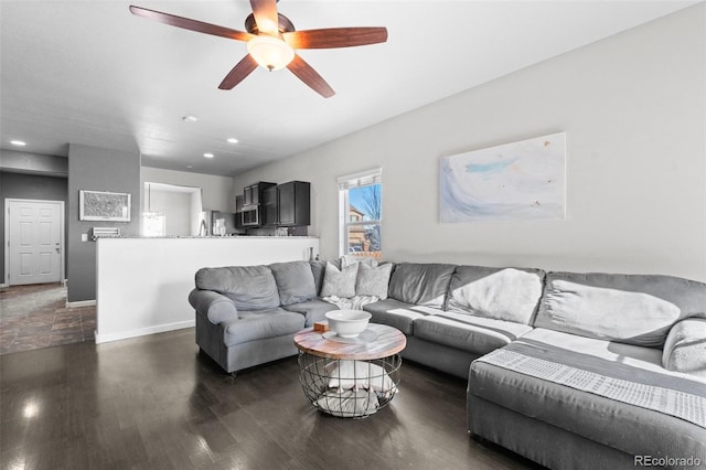 living room featuring ceiling fan and dark hardwood / wood-style floors