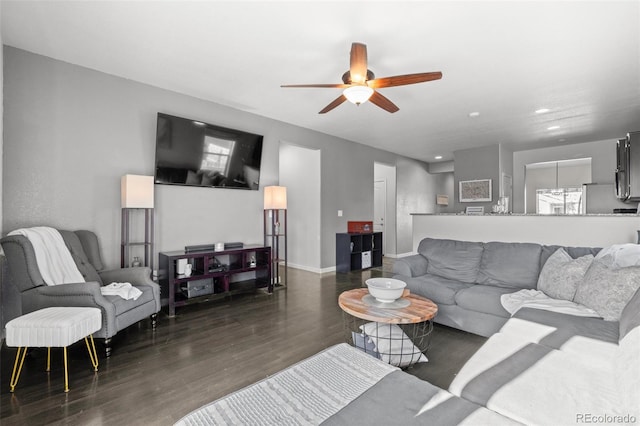 living room featuring ceiling fan and dark hardwood / wood-style floors