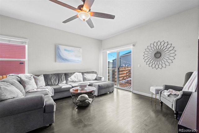 living room with ceiling fan, dark wood-type flooring, and a wealth of natural light