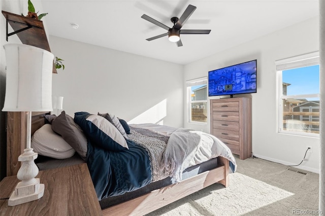 bedroom with ceiling fan and light carpet