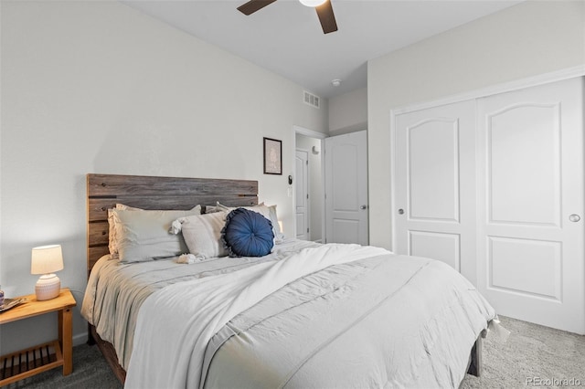 bedroom with ceiling fan, a closet, and dark colored carpet