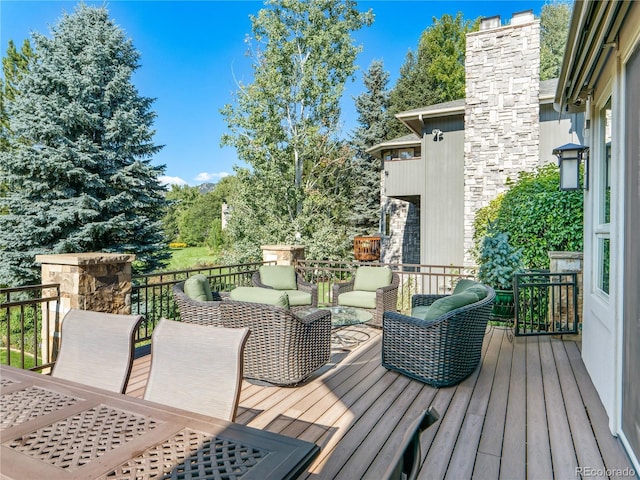 wooden terrace featuring an outdoor living space