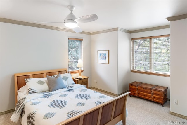 carpeted bedroom featuring ceiling fan and ornamental molding