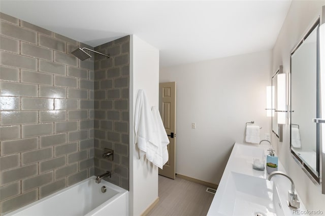 bathroom featuring vanity and tiled shower / bath combo