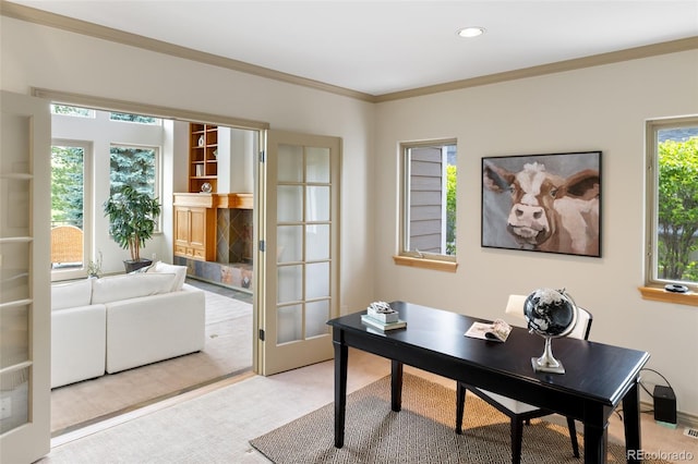 office area with ornamental molding, plenty of natural light, carpet floors, and a high end fireplace