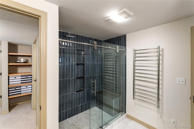 bathroom with radiator heating unit and a shower with shower door