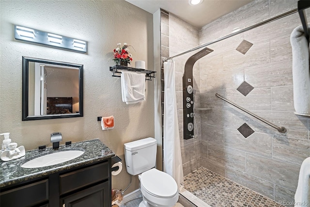 bathroom featuring toilet, vanity, and a shower with curtain