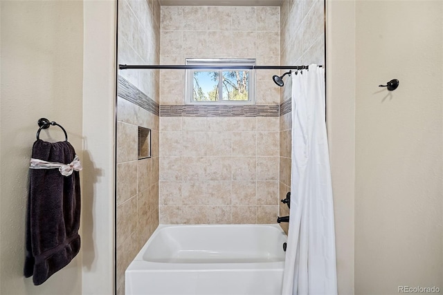 bathroom with shower / bath combo with shower curtain