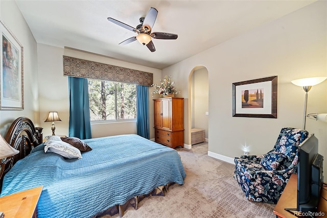 bedroom with ceiling fan and light carpet