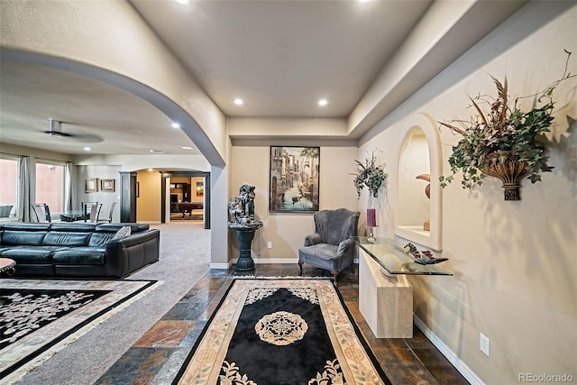 interior space featuring dark colored carpet and decorative columns