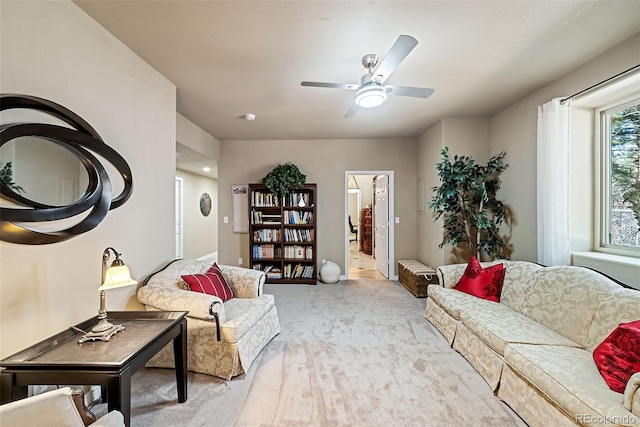 interior space featuring light colored carpet and ceiling fan