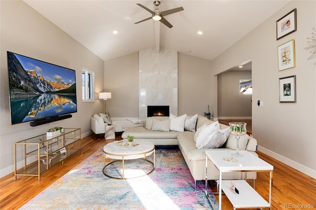 living area with vaulted ceiling with beams, baseboards, and wood finished floors