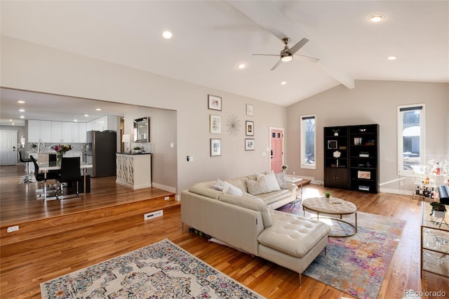 living area with vaulted ceiling with beams, light wood-type flooring, baseboards, and recessed lighting