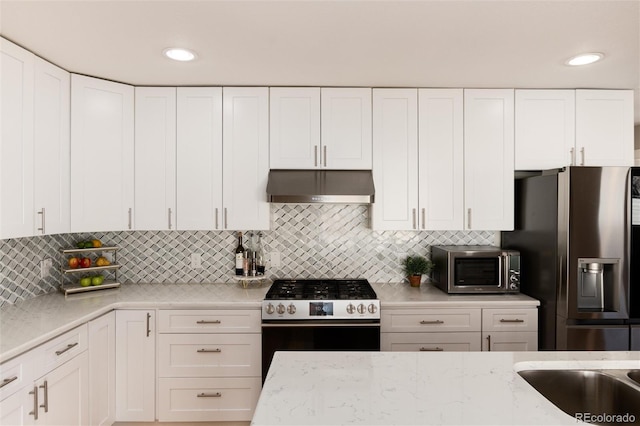 kitchen featuring appliances with stainless steel finishes, white cabinetry, and under cabinet range hood