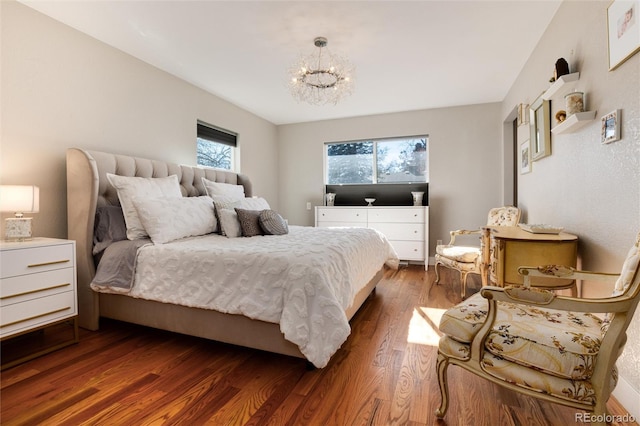 bedroom featuring dark wood-type flooring and a notable chandelier