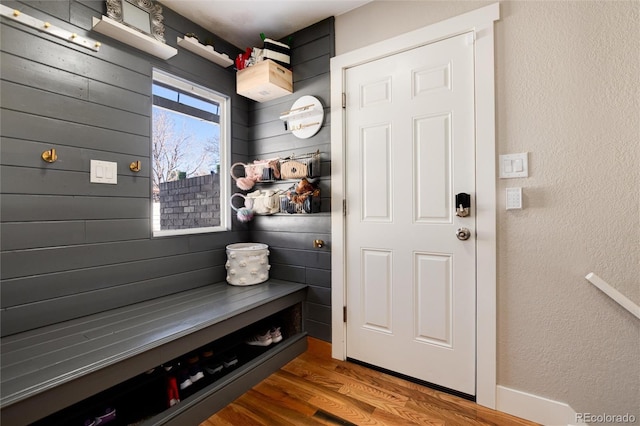 mudroom with a textured wall and wood finished floors