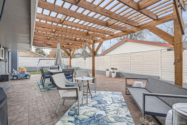 view of patio with a fenced backyard, outdoor dining area, and a pergola