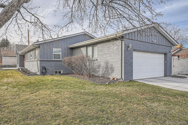 view of side of property featuring brick siding, a yard, board and batten siding, a garage, and driveway