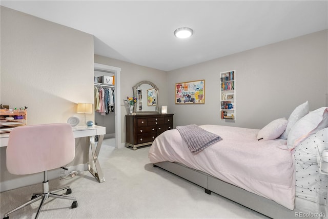 7155 E Exposition Ave, Denver, CO 80224 - bedroom with a spacious closet, light carpet, an office area, and a closet